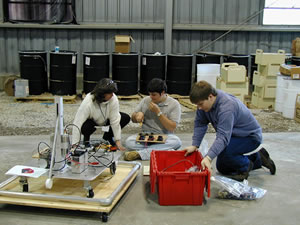Mrs. Meeks, Randolph, and Matt working on the robot
