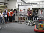 Clinton High School students watching the robot go around the shop